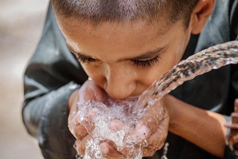 Thirsty Pakistani Boy Drinking Water