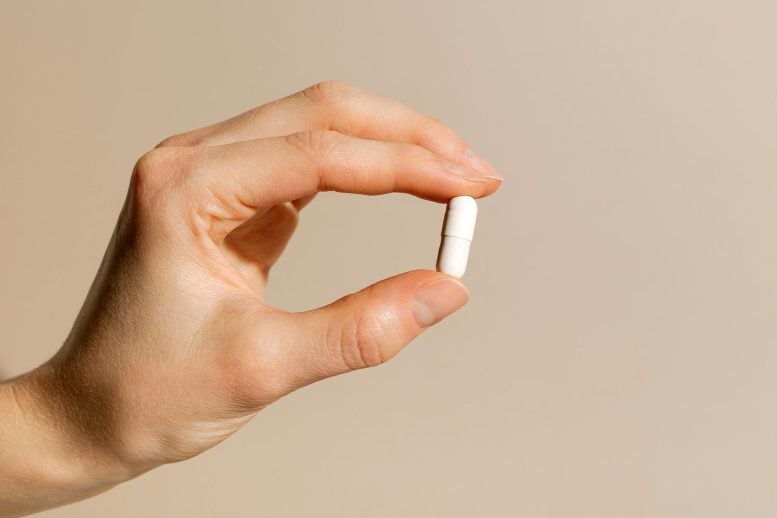 Female Hand Holding Vitamin Supplement Medicine Pill Capsule